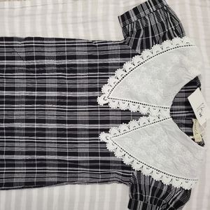 Girl's black and white plaid dress, button back, white lace collar